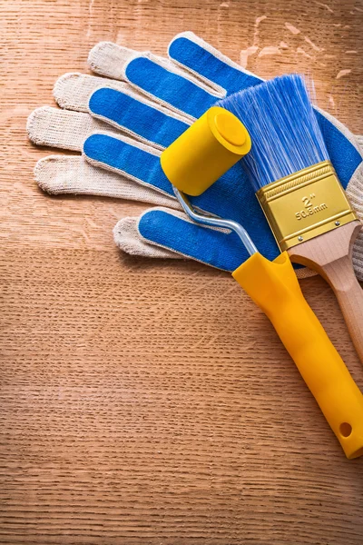 Gloves with paint roller and brush — Stock Photo, Image