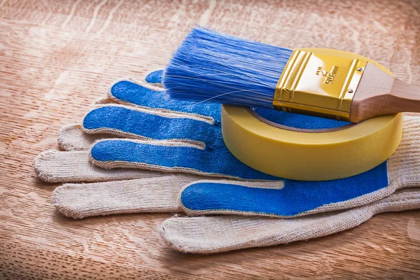 Safety gloves with paint brush — Stock Photo, Image