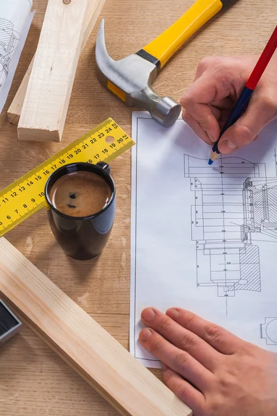 Hands of worker with pencil and blueprint — Stock Photo, Image