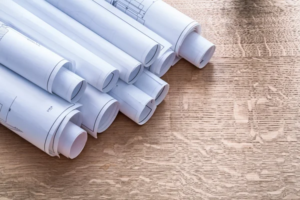 Set of blueprint rolls on wooden  board — Stock Photo, Image