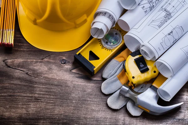 Blueprint rolls and set of construction tools — Stock Photo, Image