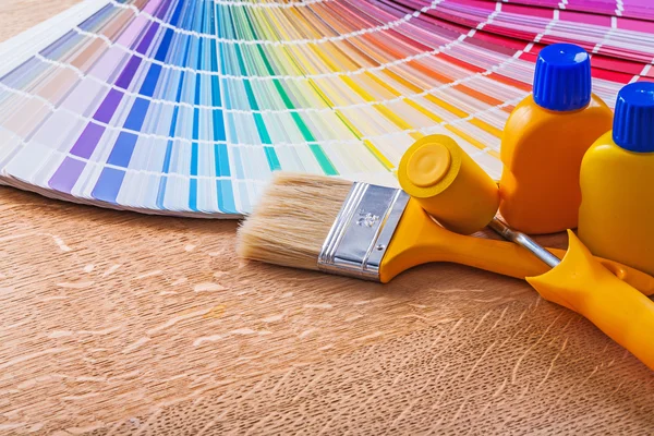 Bottles with paint paintbrush and roller — Stock Photo, Image