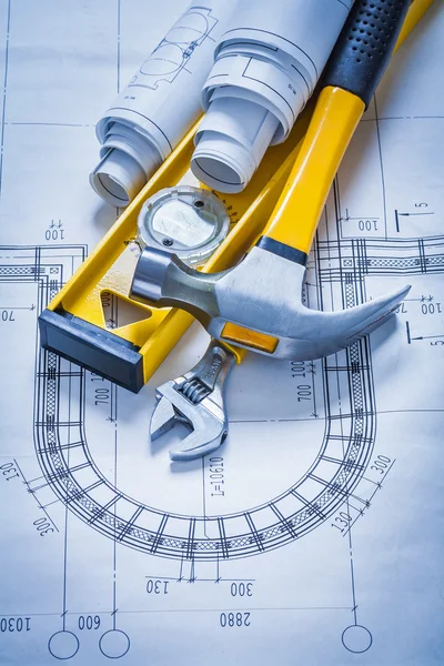 Construction level, hammer, spanner, blueprints — Stock Photo, Image