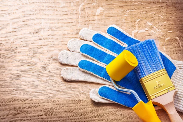 Blue working gloves with paint brush — Stock Photo, Image