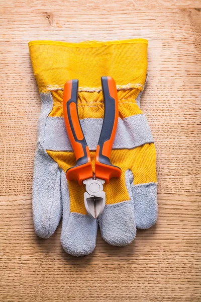 Nippers on protective glove — Stock Photo, Image