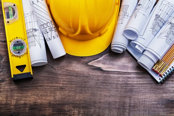 Notepad blueprints and hard hat — Stock Photo, Image