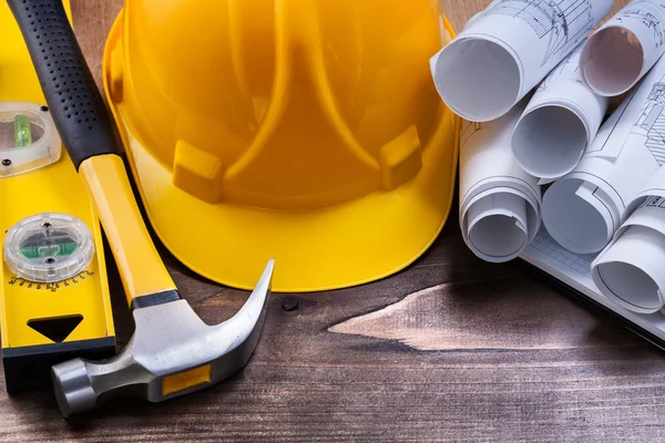 Construction tools and blueprints on table — Stock Photo, Image