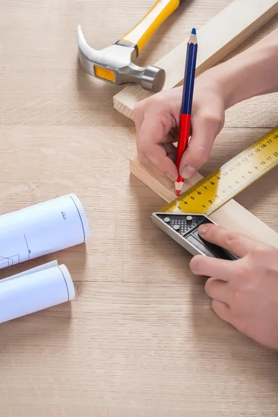 Joiner do scetch on wooden plank — Stock Photo, Image