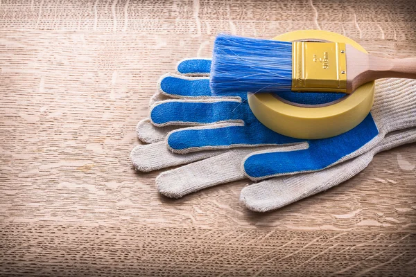 Paint brush on duct tape and gloves — Stock Photo, Image