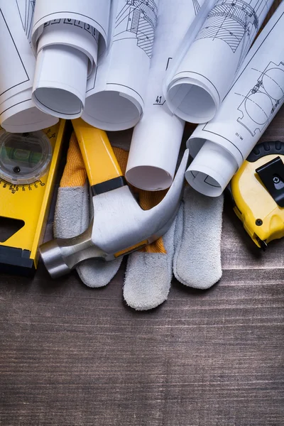 Rolls of blueprints, hammer, protective glove — Stock Photo, Image