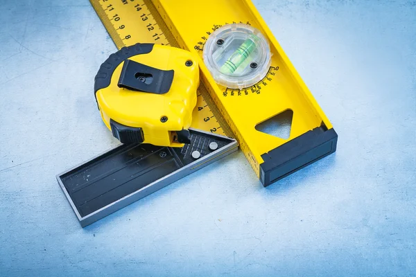 Tape line, construction level and square ruler — Stock Photo, Image