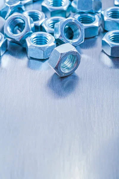 Stainless screw nuts on metallic background — Stock Photo, Image