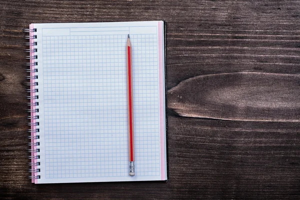 White checked copybook with red pencil — Stock Photo, Image