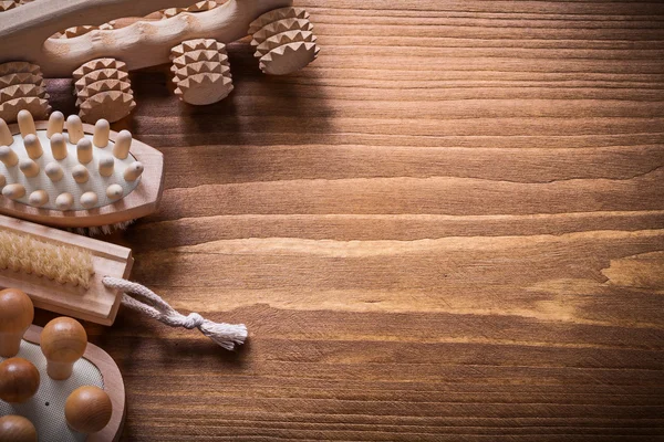 Massagers on brown wooden board — Stock Photo, Image