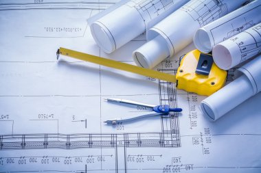 blueprints, compass and yellow tapeline