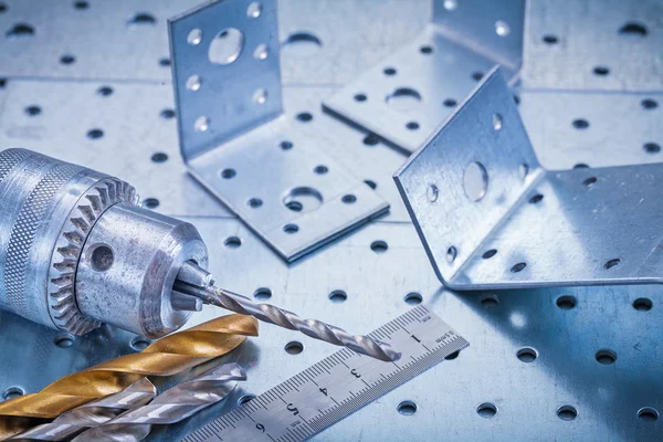 Metal ruler, drill, boring bits