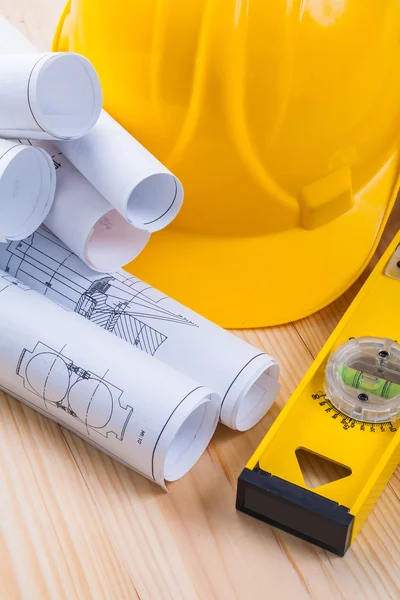 Blueprints, helmet and construction level — Stockfoto