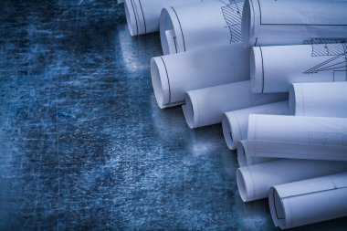 heap of white blueprint rolls