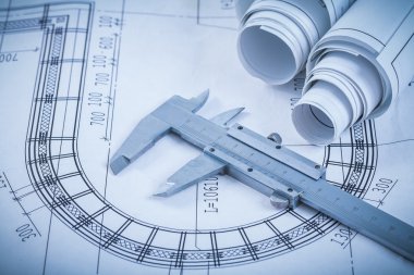 Rolled construction drawings and slide caliper