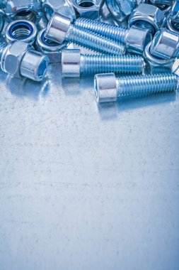 Stack of metal screw nuts and bolts