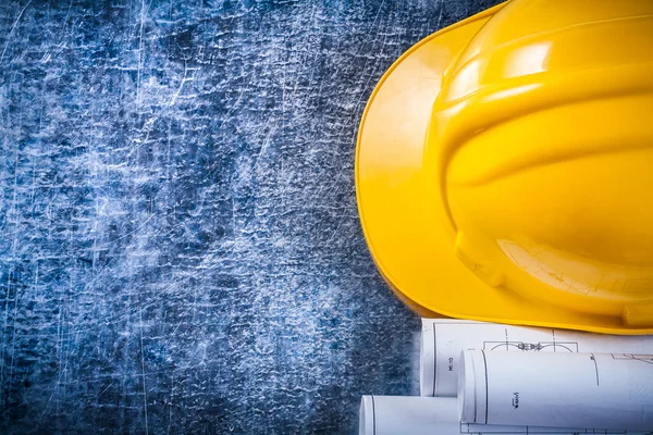 Blueprint rolls and construction helmet — Stock Photo, Image