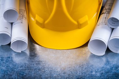 architectural blueprint rolls and helmet
