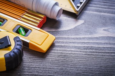 Instruments of measurement, blueprints and construction level