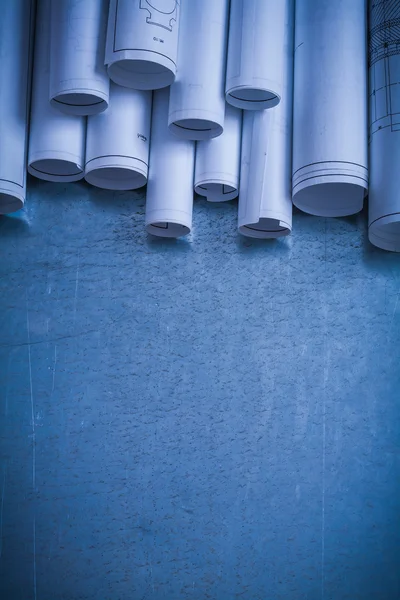 Rolled up white architectural blueprints