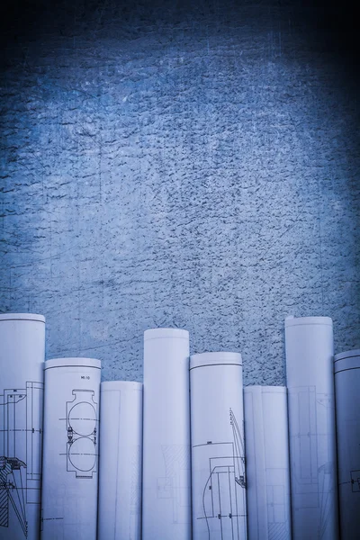 Scratched metallic surface with blueprint rolls — Stock Photo, Image