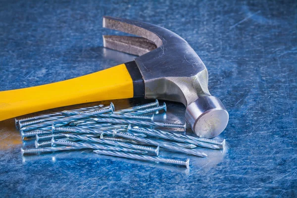 Metal construction nails with claw hammer — Stockfoto