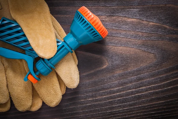 Spray hose nozzle and safety gloves — Stock Photo, Image