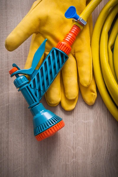 Safety gloves and hand spraying hose — Stock Photo, Image