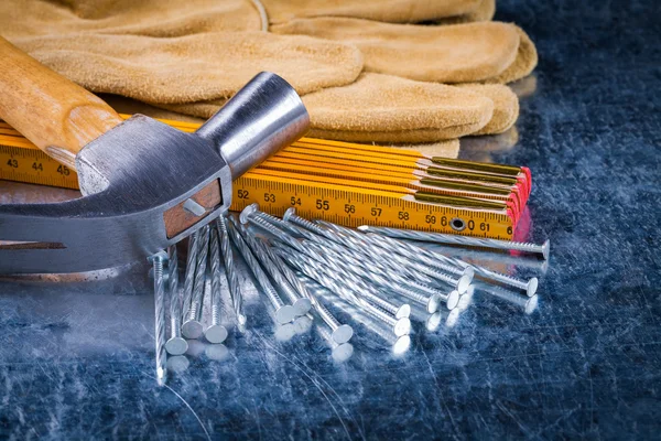 Gloves, nails, wooden meter and hammer — Stock Photo, Image