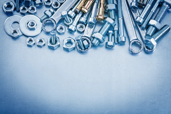 Bolt washers, screwbolts, nuts and spanner — Stock Photo, Image