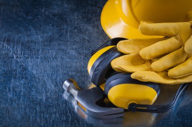 Building helmet, earmuffs, gloves and hammer