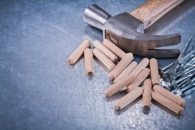 hammer, construction nails and wooden dowels