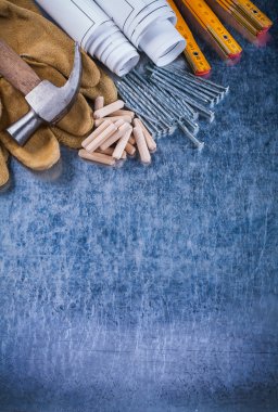 Plans, hammer, gloves, meter, nails