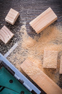 Electric jigsaw sawdust and wooden planks