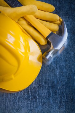protective gloves, building helmet and hammer