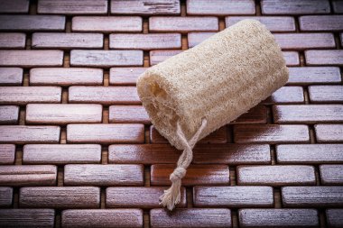 Loofah on textured wooden matting