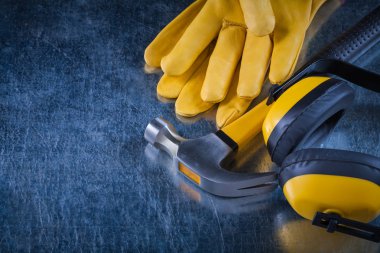 ear muffs, hammer and leather gloves