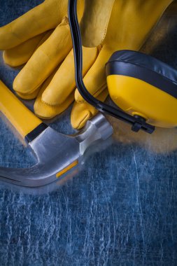 ear muffs, hammer and leather gloves