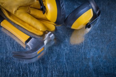ear muffs, hammer and leather gloves