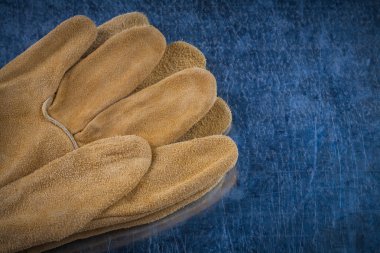 Pair of leather brown protective gloves