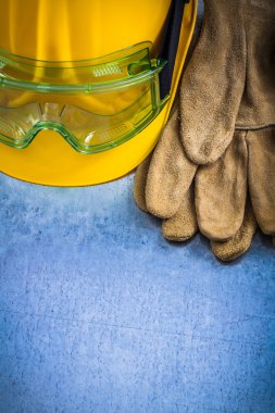 gloves, building helmet and protective goggles