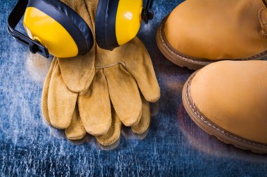 safety boots, leather gloves and headphones