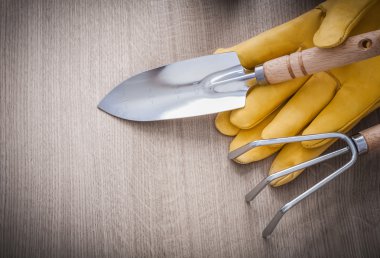 spade, rake, yellow gardening gloves