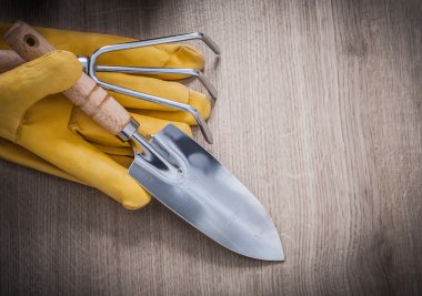 spade, rake, yellow gardening gloves