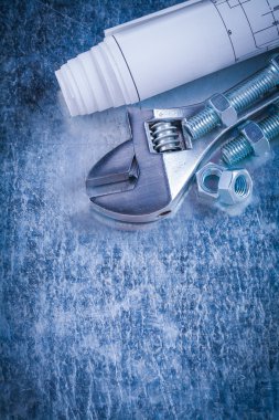 spanner, construction nuts, bolts and blueprints