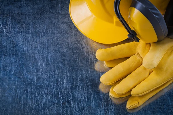 Building helmet, earmuffs and protective gloves